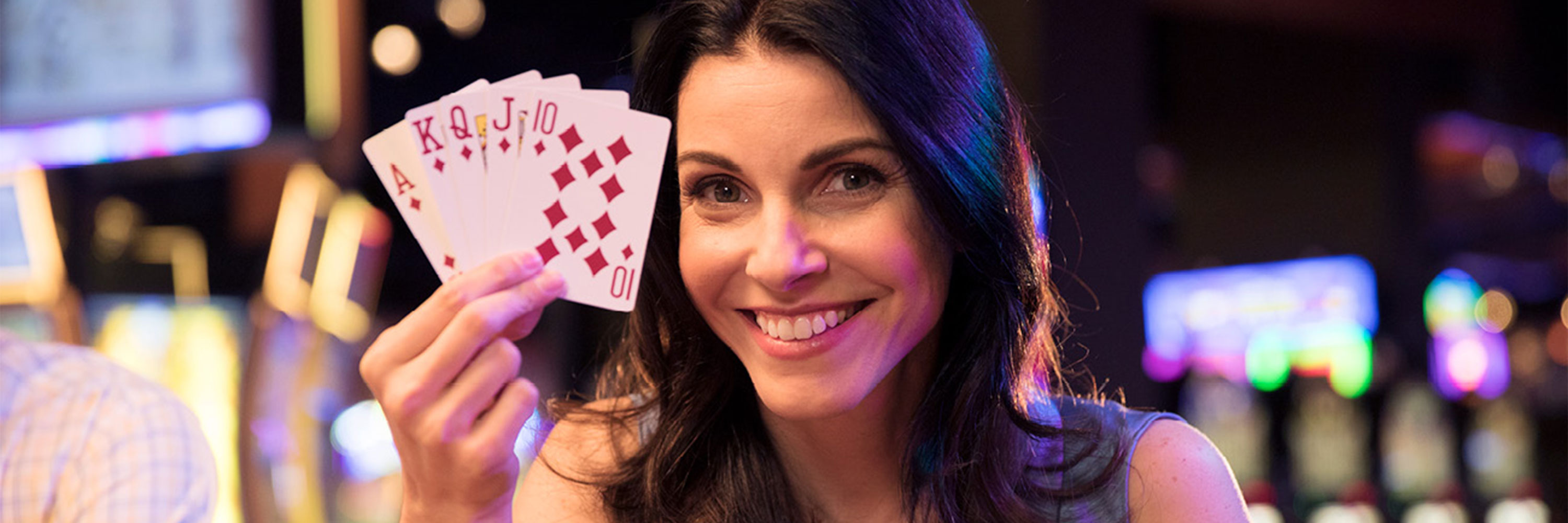 Photo of woman holding cards and smiling